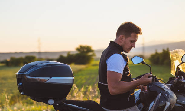 istock Motorcyclist adjusting crash helmet 1322659619