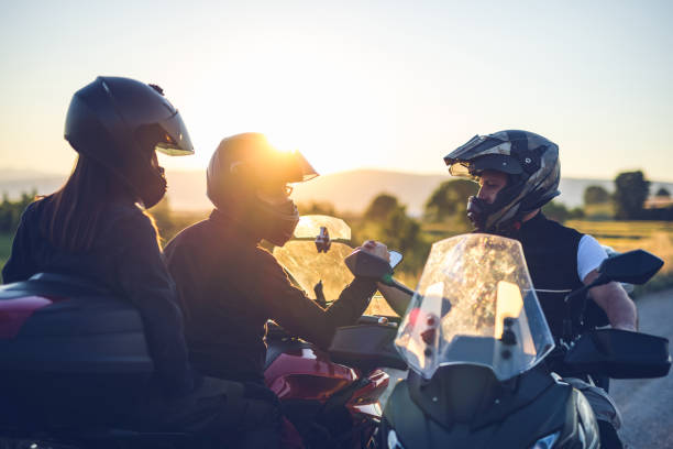 istock Motorcyclists greeting each other on the road at sunset 1322659622