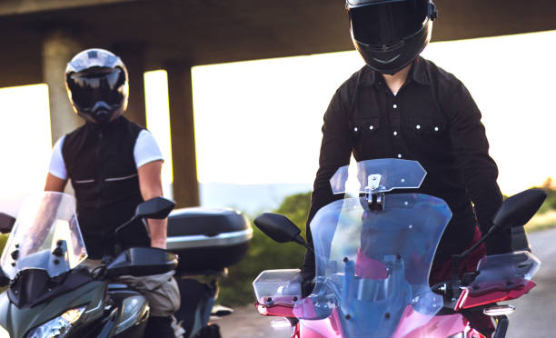 istock Two motorcyclists rides bikes on the road at sunset 1322659712