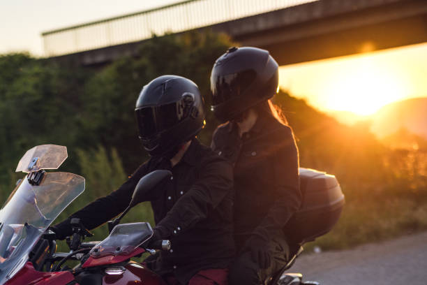 istock Couple enjoys ride on motorcycle at sunset 1322659761