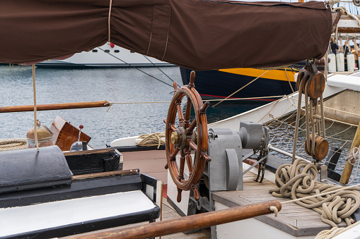 Picture of a wooden helm in the deck of a vintage vessel