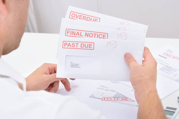 Close-up Of A Man Holding Statements Of Pending Dues Close-up Of A Man Holding Statements Of Pending Dues past due stock pictures, royalty-free photos & images