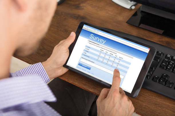 istock Businessman Filling Survey Form On Digital Tablet 1322665897