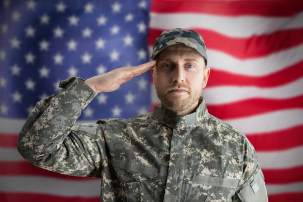 istock Military US Soldier Saluting Flag 1322669316