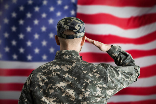 istock Military US Soldier Saluting Flag 1322669317
