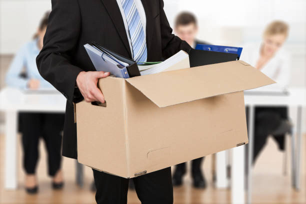istock Businessman Moving Out With Cardboard Box 1322670368