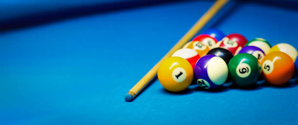 istock billiard pool balls rack and cue on the blue cloth table. banner copy space 1322670572