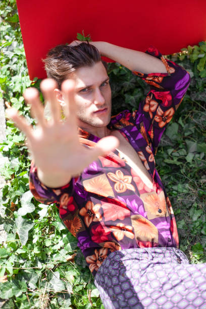 istock Handsome young man laying on the grass 1322670779