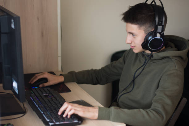 istock Young boy playing games on a computer at home 1322670856