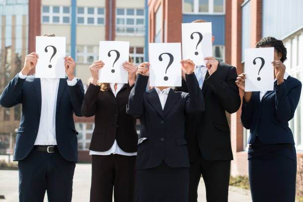 istock Businesspeople Hiding Face Behind Question Mark Sign 1322670956