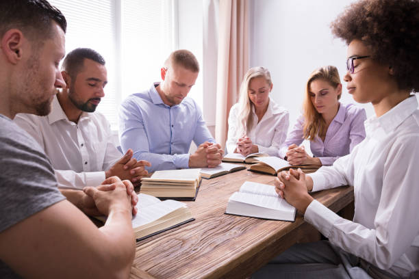istock Group Of Young Multiethnic People Reading Bible 1322670974