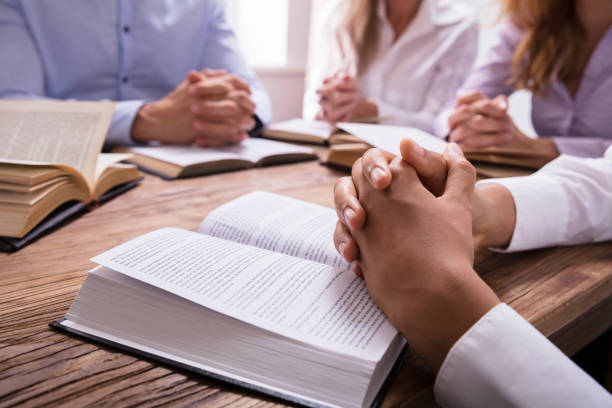 istock Woman's Praying Hand On Bible 1322670975