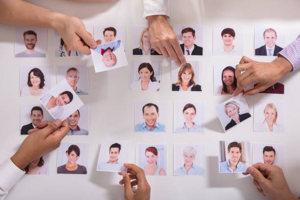 istock Group Of Businesspeople Selecting Candidate Photo 1322670977