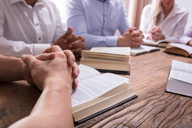 istock Man Praying Hand On Bible 1322670979