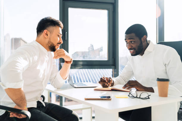 istock Two mulracial office workers hold meeting in the office 1322672307