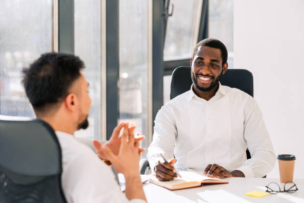 istock Business colleagues talking while sitting at the table in the office 1322672373