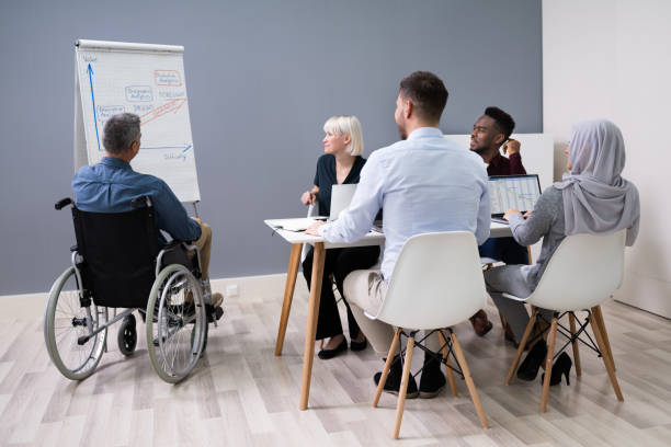 istock Disables Businessman Giving Presentation 1322673075