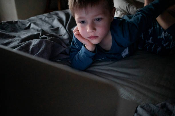 istock Kid watching cartoons on laptop 1322673139