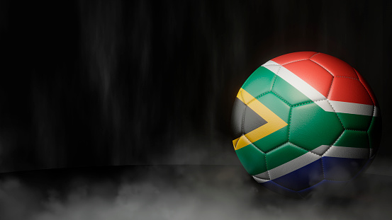 Soccer ball in flag colors on a dark abstract background. South Africa. 3D image.
