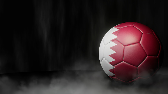 Pelota de fútbol en colores de bandera sobre un fondo abstracto oscuro. Qatar. photo