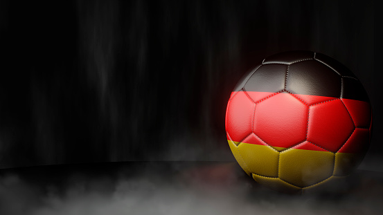 Soccer ball in flag colors on a dark abstract background. Germany. 3D image.
