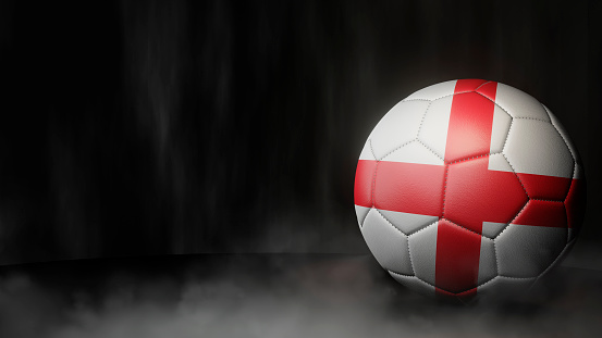 Soccer ball in flag colors on a dark abstract background. England. 3D image.