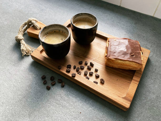 istock Two cups of coffee with a coffeeroll and coffeebeans 1322675463