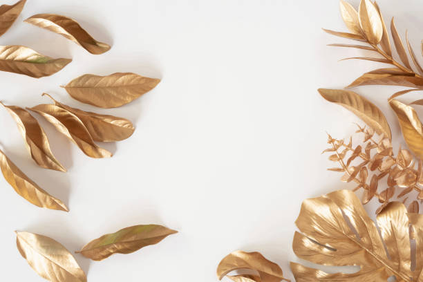 istock Gold tropical palm leaves Monstera on white background. Flat lay 1322675465