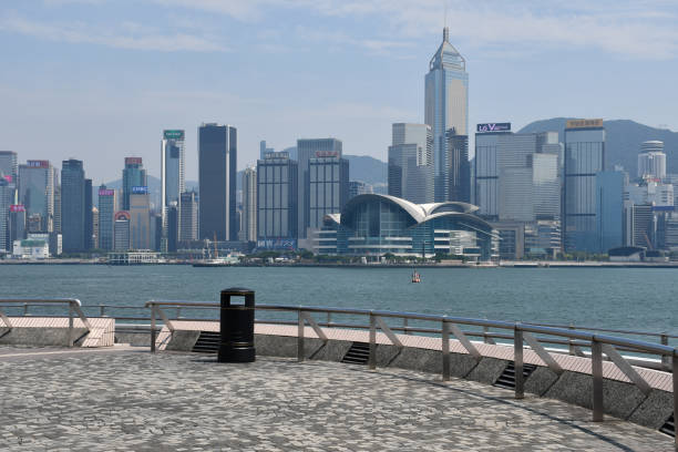 Central Plaza and Hong Kong Convention and Exhibition Centre Seen from across Victoria Harbour Hong Kong, China - August 9, 2019: Central Plaza (designed by Dennis Lau & Ng Chun Man Architects & Engineers), the Hong Kong Convention and Exhibition Centre (HKCEC; designed by Skidmore, Owings & Merrill) and the Wan Chai skyline, seen from the Tsim Sha Tsui waterfront, across Victoria Harbour. central plaza hong kong stock pictures, royalty-free photos & images