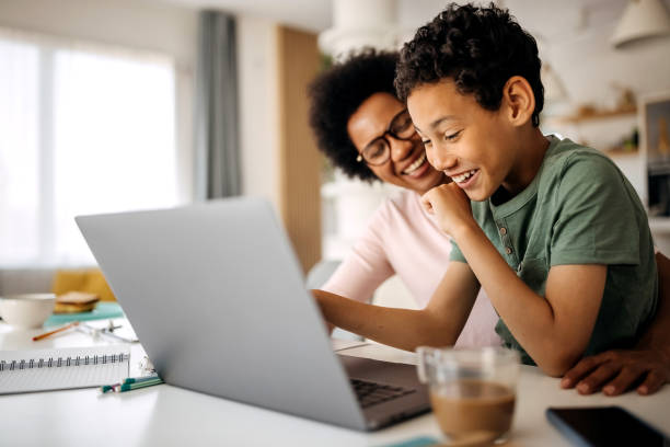 istock Mother helping son studying with laptop on a online class at home 1322676659