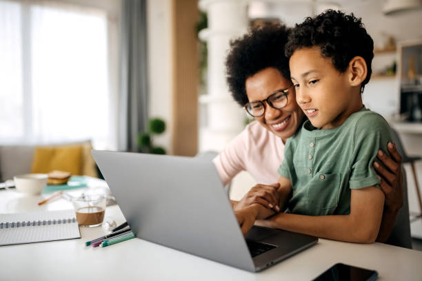 istock Mother helping son studying with laptop on a online class at home 1322676694