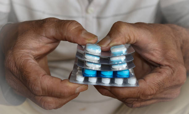 A Close up picture human hands holding few strips of Tablets pills for Medical emergency. A Close up picture human hands holding few strips of Tablets pills for Medical emergency. capsule collection stock pictures, royalty-free photos & images