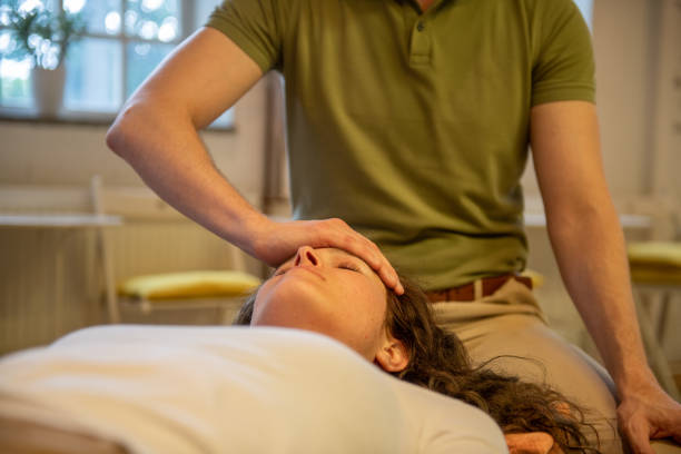 istock Man therapist practicing Somatic movement in his Health Studio, Awareness through movement, embodiment and Feldenkrais Method 1322677726