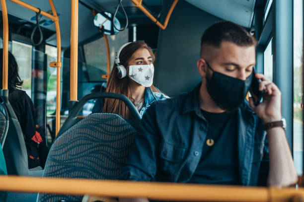 istock Young passengers in the bus wearing protective mask and using smartphone 1322677888