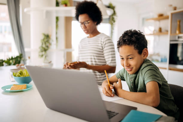 istock Teenage boy studying from home on a laptop 1322678011