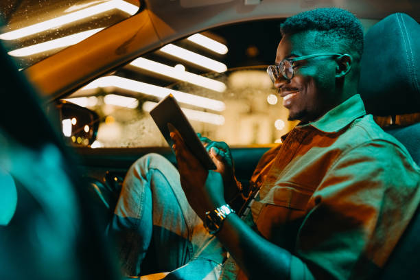 istock Young handsome man having online conversation in a car 1322680097