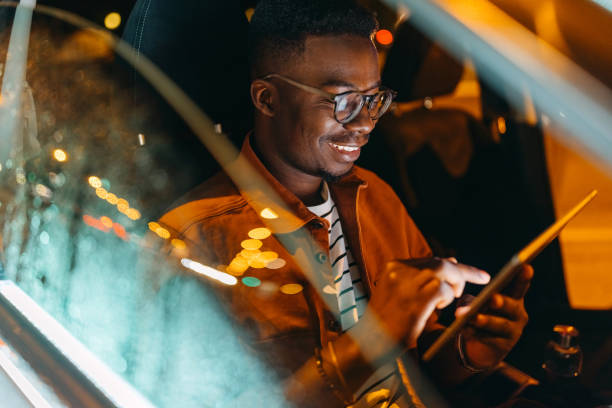 istock Young handsome man having online conversation in a car 1322680232