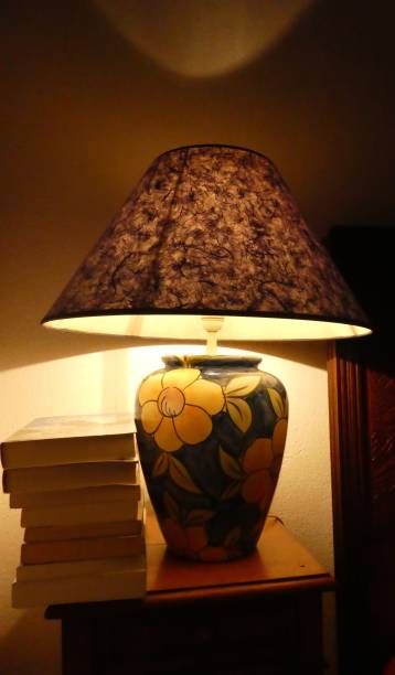 istock bedside lamp lit and some books for evening reading 1322684733