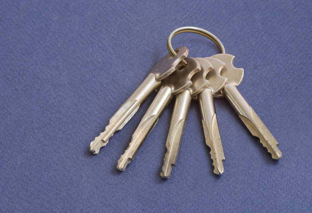 Bunch of keys on a dark-blue background closeup.