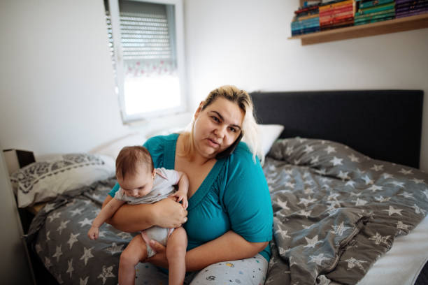 istock Mother breastfeeding and using smart phone 1322685899