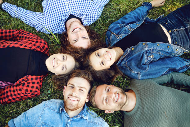 istock Friends lie on the grass in the park. 1322685965