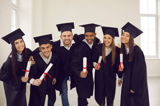 istock Group of classmates university graduates feeling happy with successful getting diplomas 1322686318
