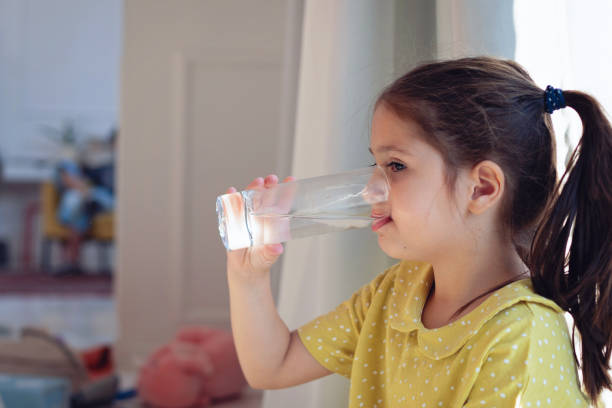 istock Thirsty girl drinking a water 1322688523