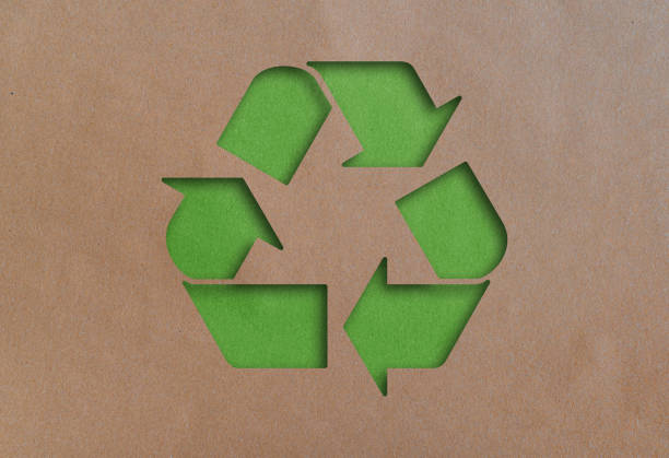 recycling symbol cut out of recycled paper stock photo
