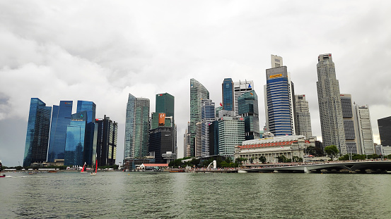 Singapore- 1 Jun, 2019: Singapore city skyline with embankment by downtown core in overcast weather