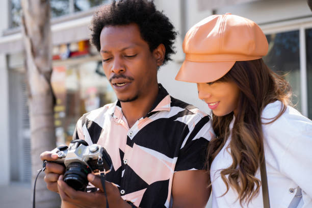 istock Tourist couple using camera outdoors. 1322689810