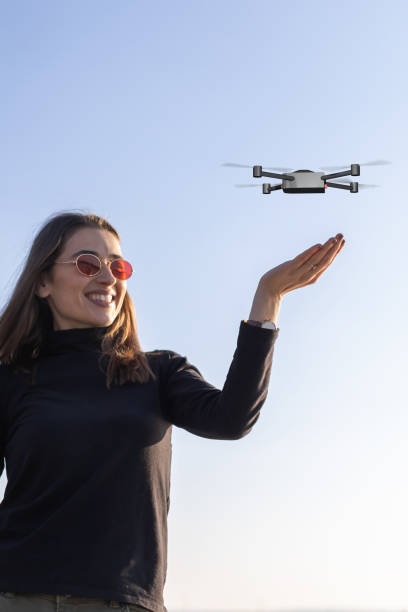 istock tiny drone landing on young woman's palm 1322690397