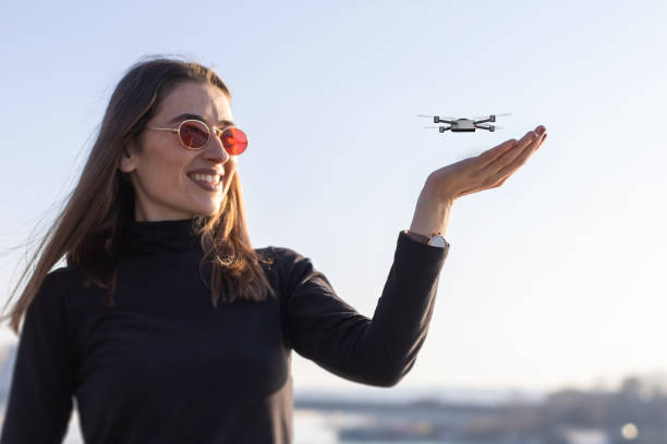 istock small drone landing on young woman's palm 1322690398