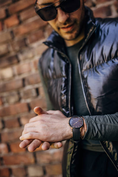 istock Fashionable man by a brick wall 1322690399