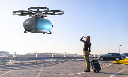 flying transportation drone picking up a passenger